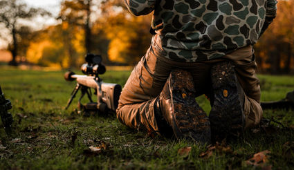 Man kneeling next to his shooting set up