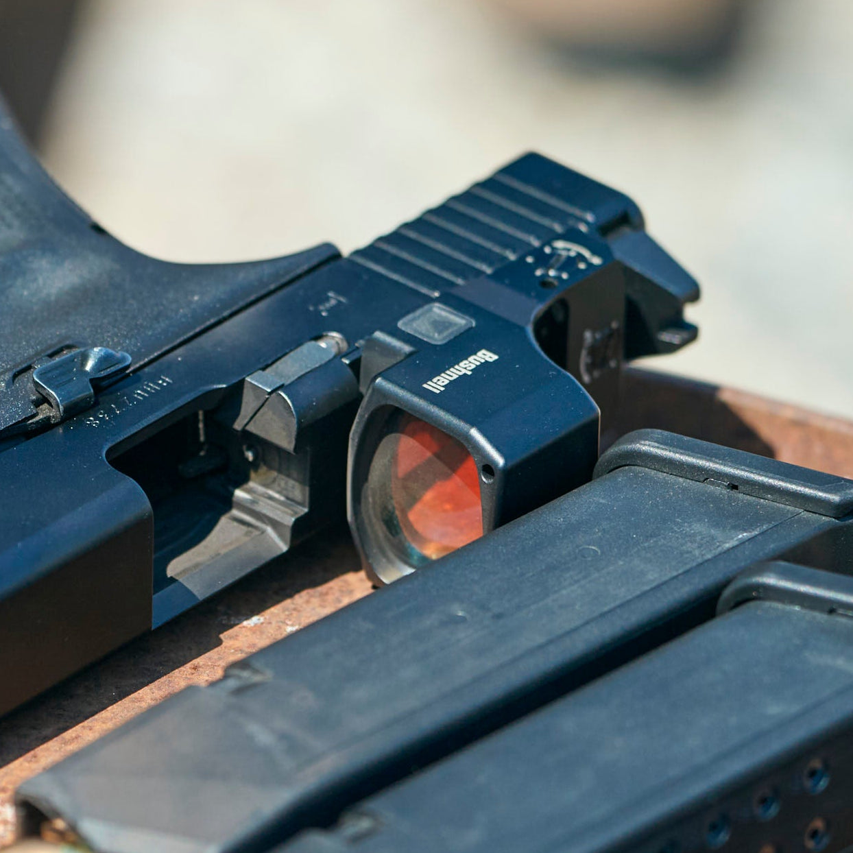 Black handgun with magazine on a wooden surface
