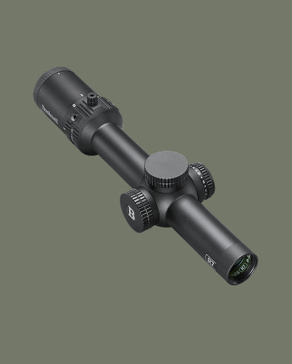 A black tactical rifle scope with textured adjustment knobs, shown at an angle against a solid dark olive green background.