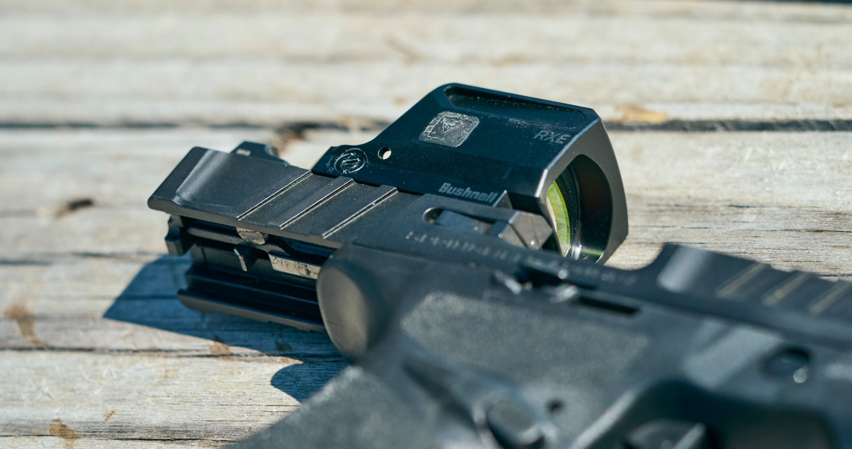 Rifle with a red dot sight on a wooden surface