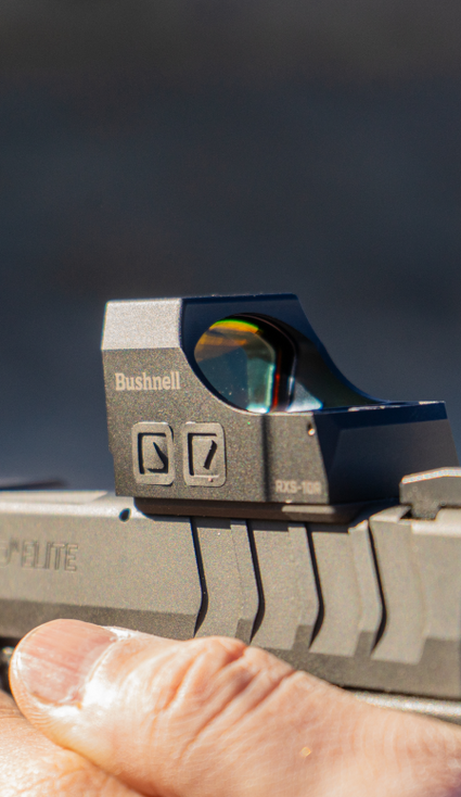 Close-up of a Bushnell sight on a rifle with a blurred background