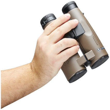 Hand holding a pair of brown binoculars on a white background