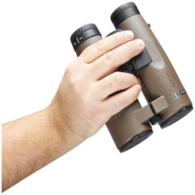 Hand holding a pair of brown binoculars on a white background