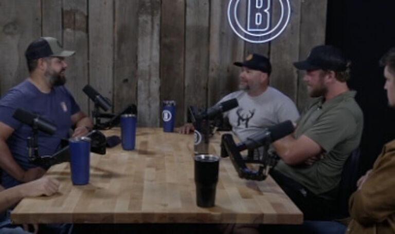 Group of people sitting at table recording podcast