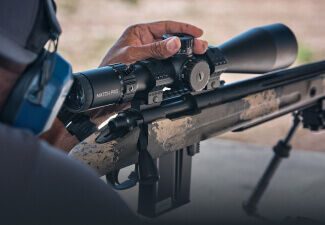 Target shooter adjusting Match Pro ED Riflescope