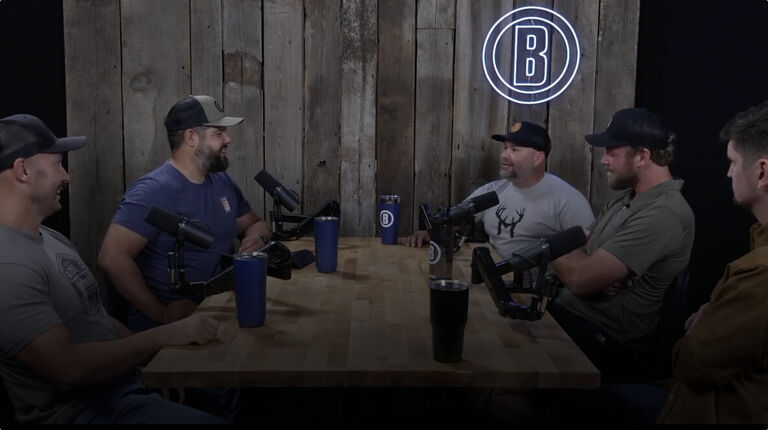 Five people including Midwest Whitetail talking at a table recording a podcast