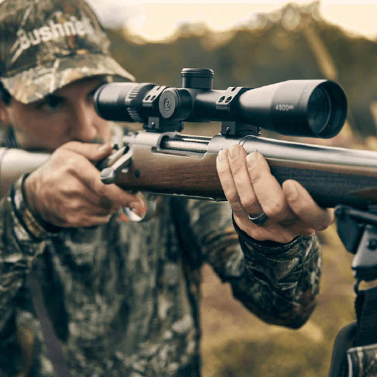 Hunter aiming through Elite 4500 Riflescope