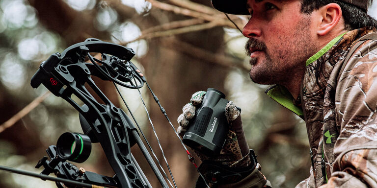 Bow hunter holding Prime 1800 Laser Rangefinder