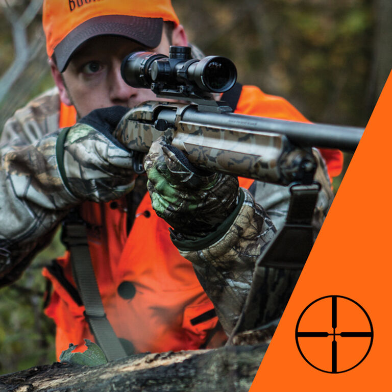 Hunter aiming through riflescope with traditional crosshairs reticle