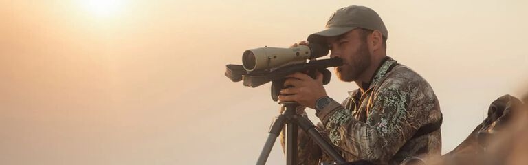 Man looking through a Bushnell spotting scope