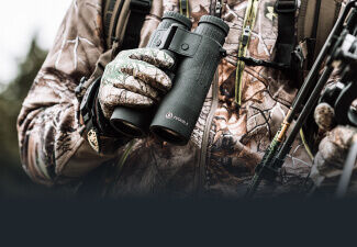 Bow hunter holding Fusion X 10x42 Rangefinding Binoculars