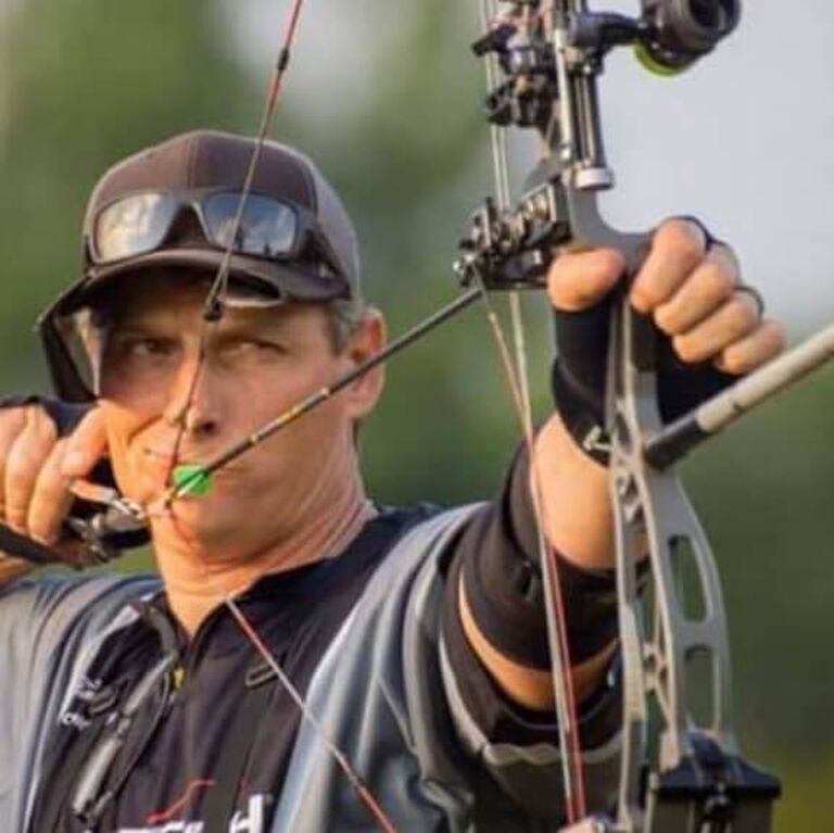 Portrait of Tim Gillingham aiming bow