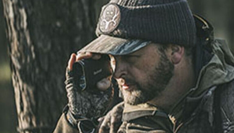Bone Collector Micheal Waddell looking through Bushnell Rangefinder