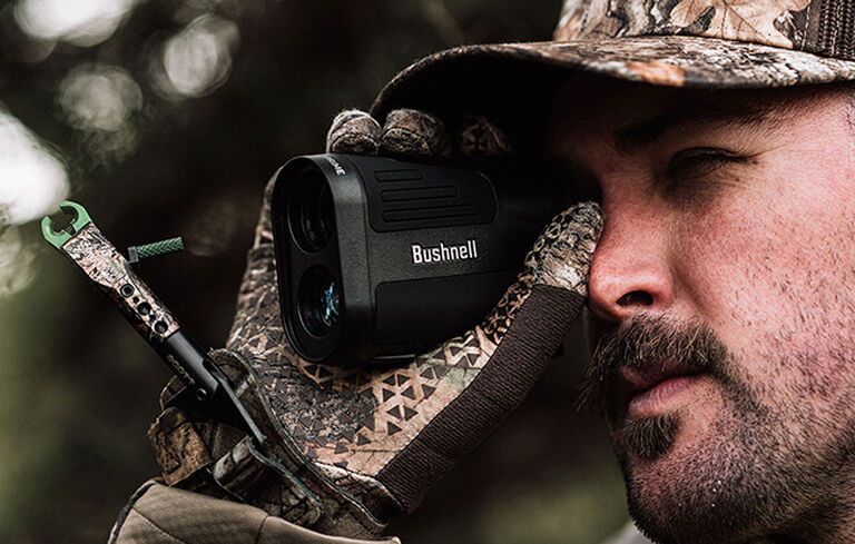 Bow hunter looking through Prime 1800