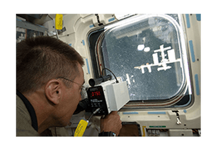 NASA astronaut using a laser rangefinder