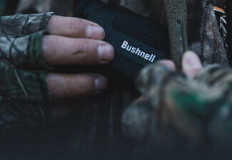 Hunter holding Bushnell Rangefinder