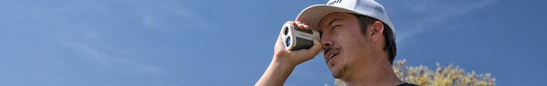 Disc Golfer looking through Bushnell Edge Rangefinder