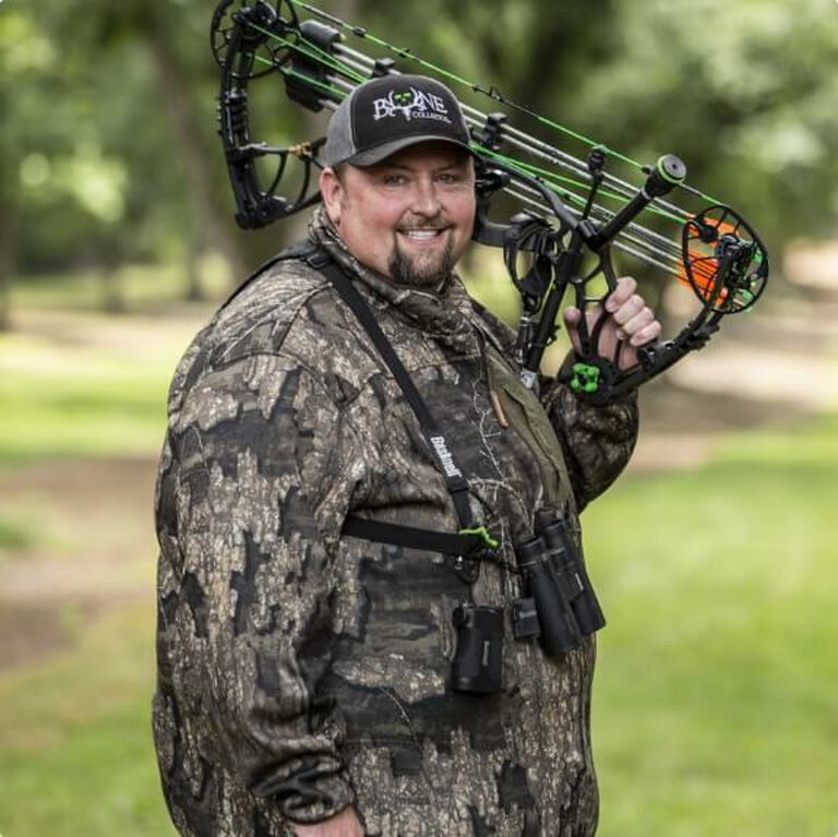 Portrait of Bone Collector Travis T-Bone Turner standing in camouflage gear