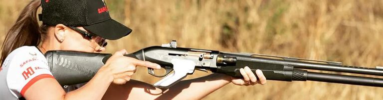 Maggie aiming with a reflex sight