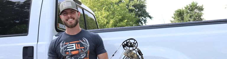 Joel Burham holding his bow