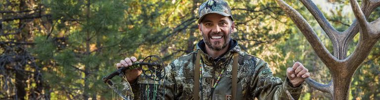 Nick Mundt holding a shed and bow