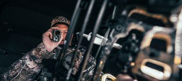 Man using Bushnell rangefinder Man using Bushnell rangefinder