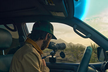 Man doing Using a Bushnell spotting scope Man doing Using a Bushnell spotting scope
