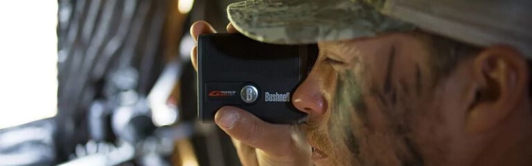 Man using rangefinder,