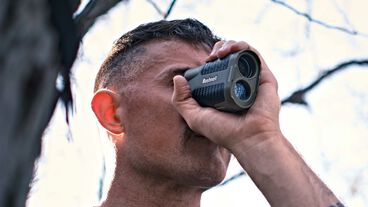 Man using Bushnell rangefinder Man using Bushnell rangefinder