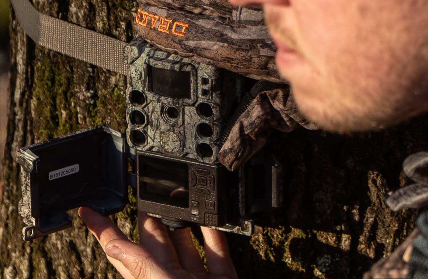 S-4K Trail Camera strapped to a tree in the woods