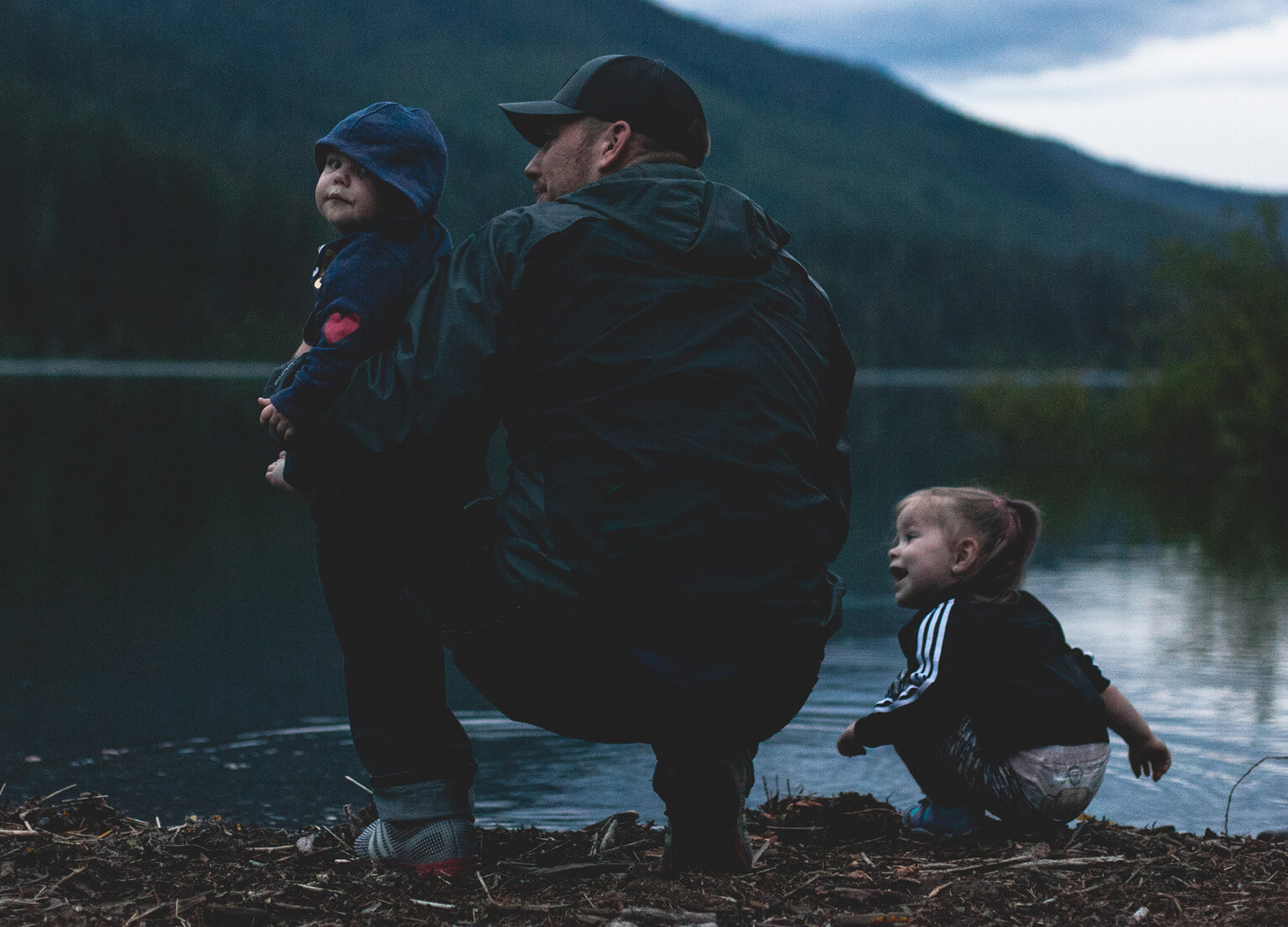Father with children by lake