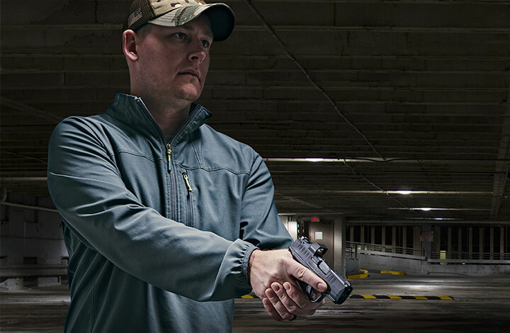 Man holding pistol with RX Micro Reflex Sight attached