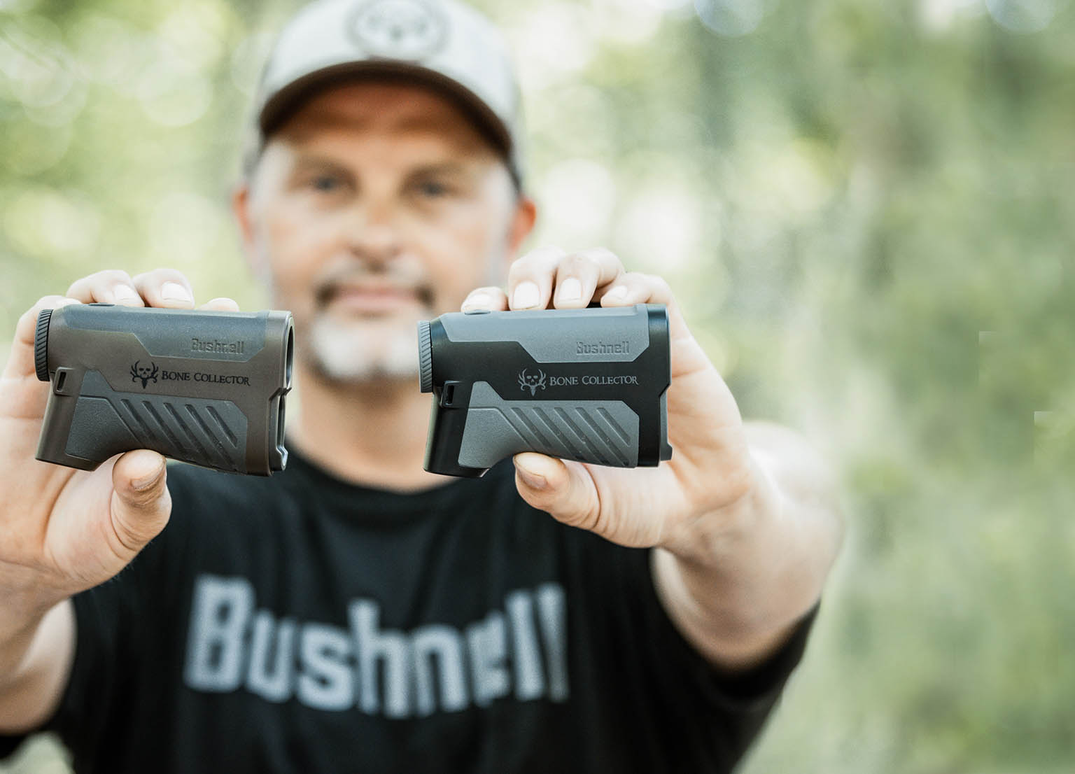 Hunter holding two Bone Collector Laser Rangefinders 1000 and 1800