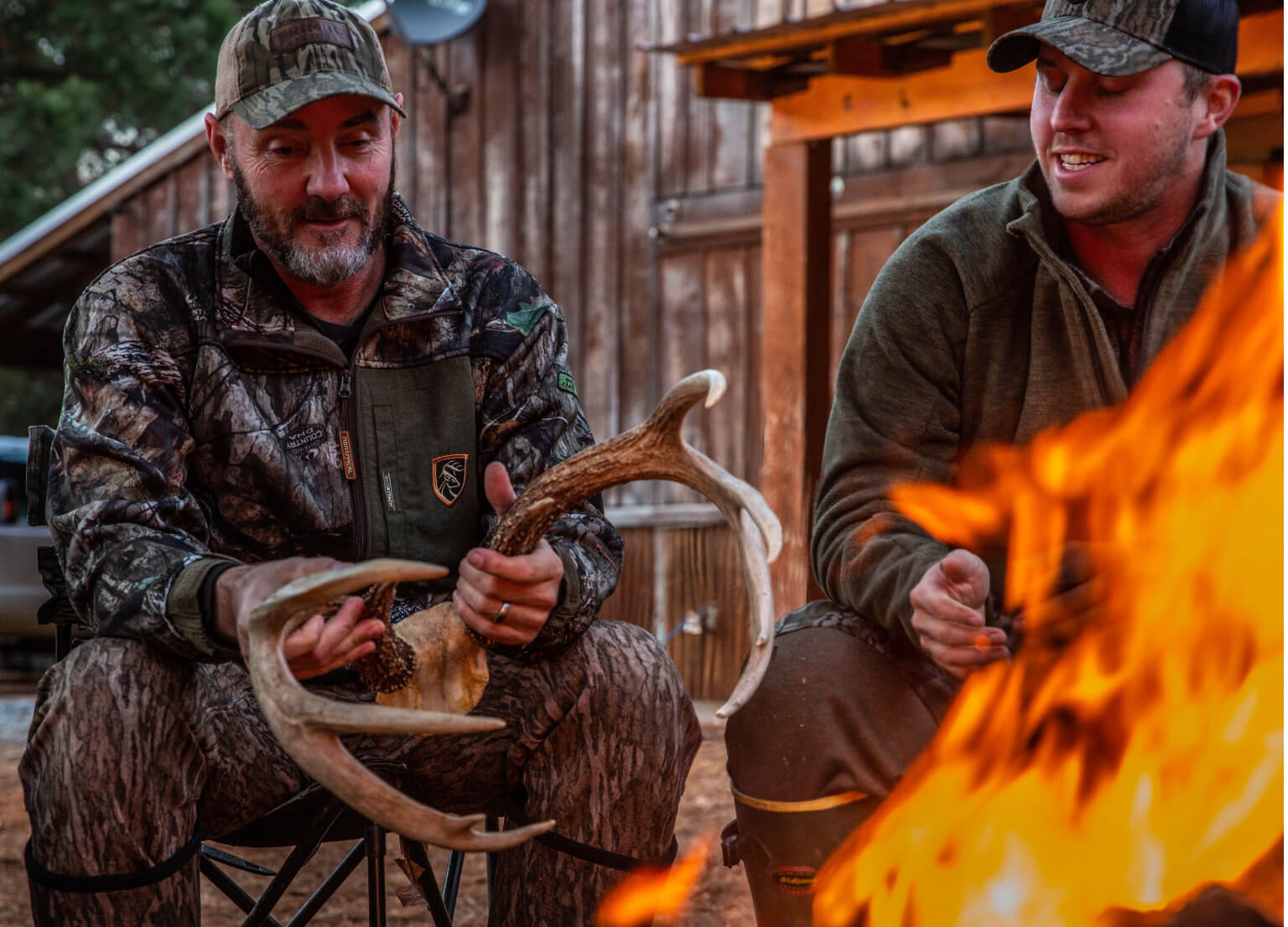 Professional guides sitting at a campfire