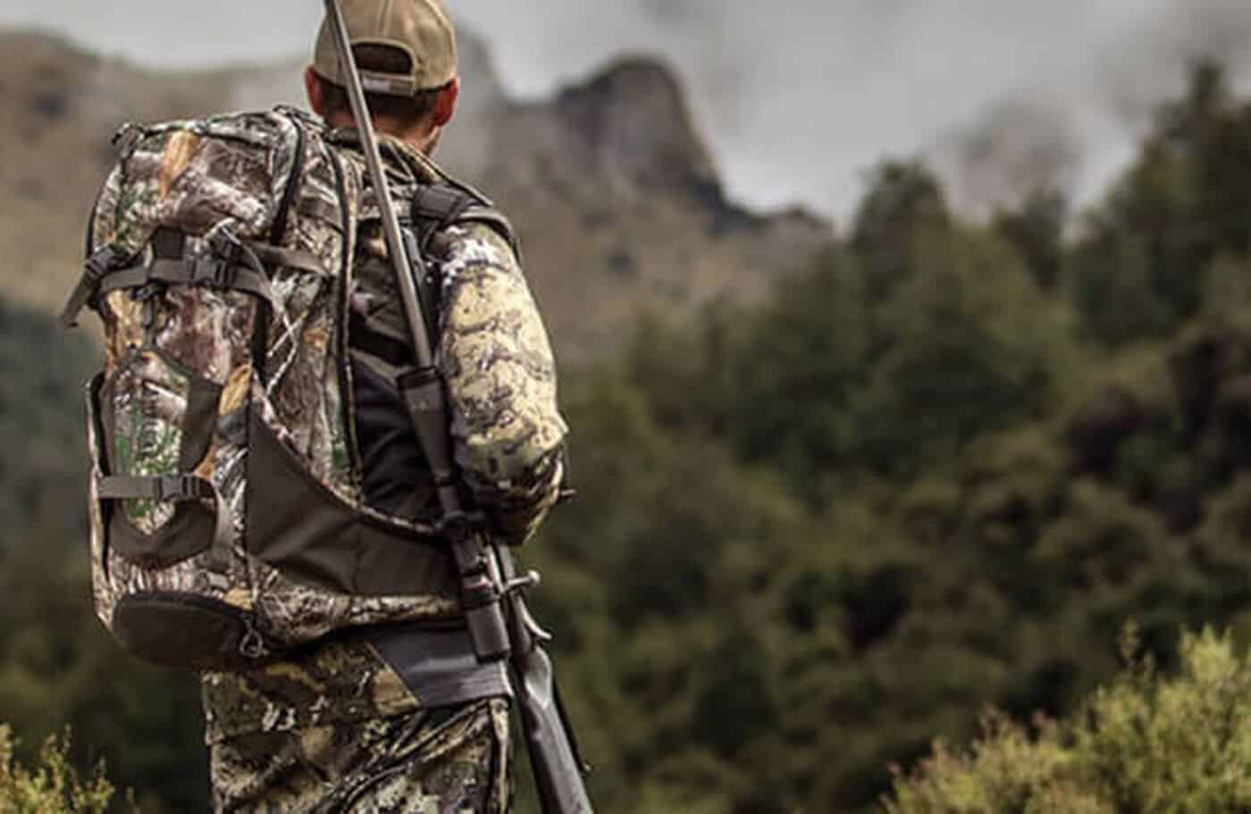 Hunter looking out over a mountain landscape