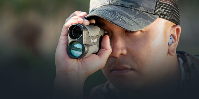 Man looking through Prime 1700 Laser Rangefinder